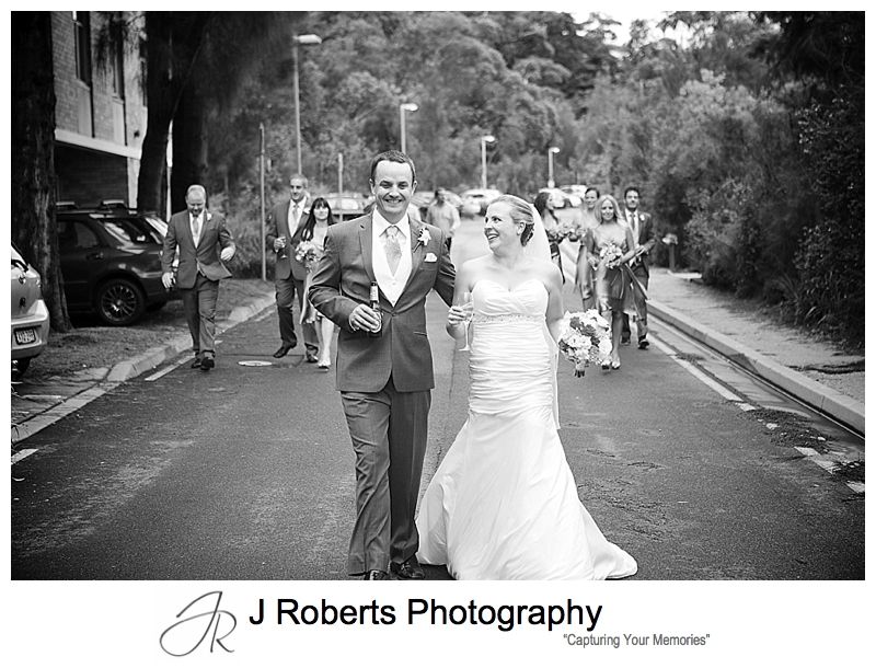 Bridal party walking along the road outside sergeants' mess chowder bay - sydney wedding photography 